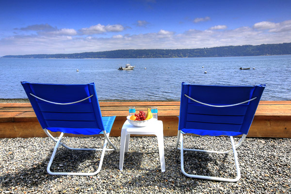 The sound of the waves lapping on the shore, the sunshine, a comfortable chair--The Beach House at Tyee offers guests the very best of Camano Island