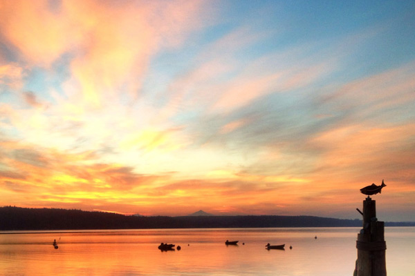 A marine layer over Port Susan Bay results in a breathtaking sunrise, seen from the balcony at The Beach House at Tyee.